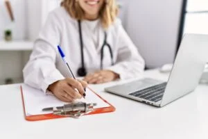 young hispanic woman wearing doctor stethoscope working at clinic